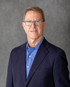 A Portrait of Brian in a Navy Blue Color Suit