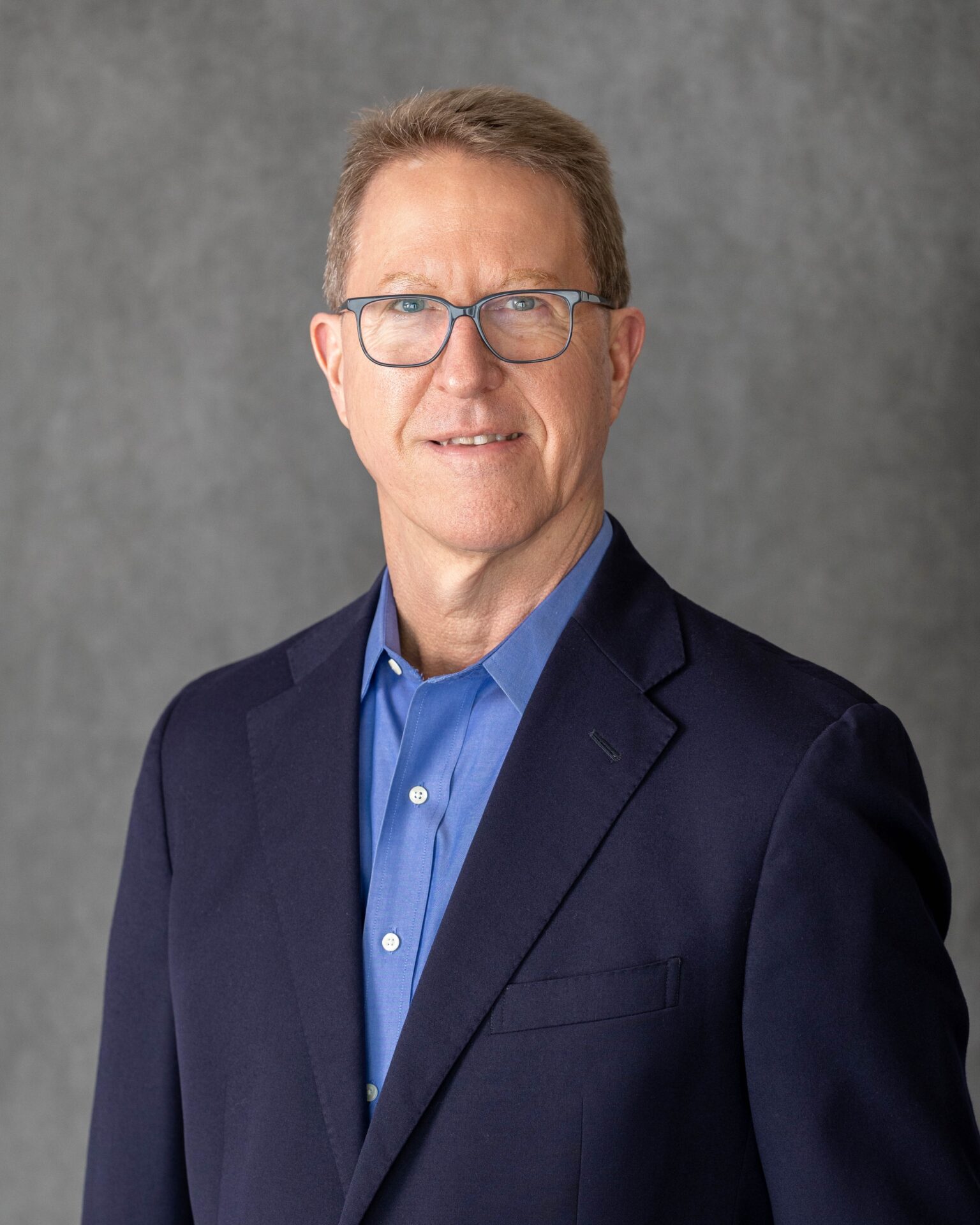 A Portrait of Brian in a Navy Blue Color Suit